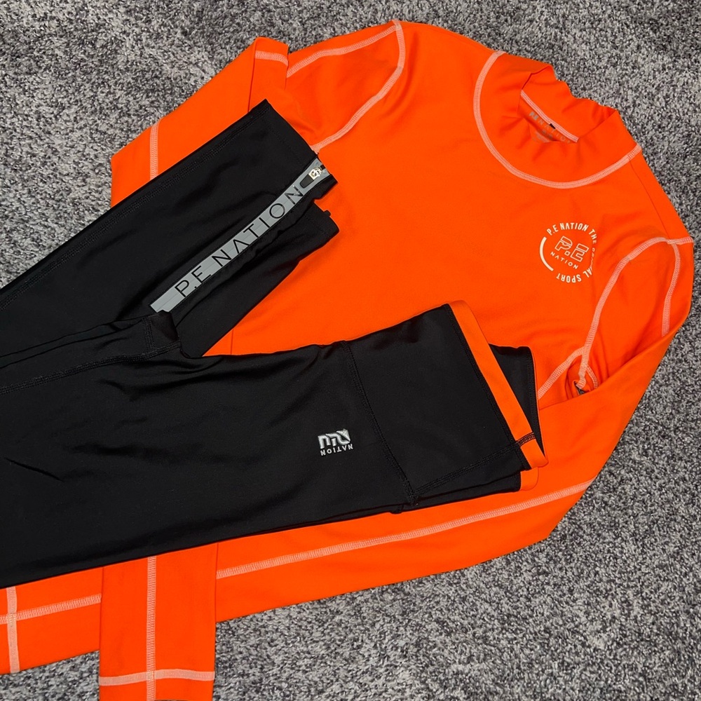 P.E Nation Bright Orange Top and Black Leggings